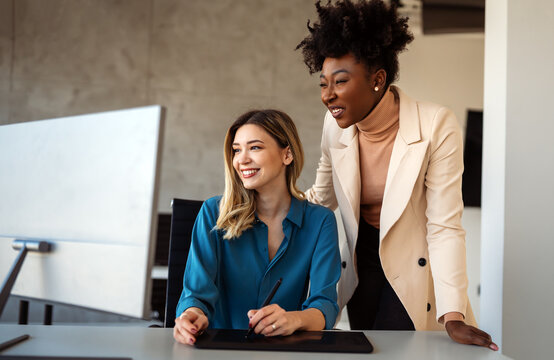 Diverse startup, business people working together on laptop computer in modern office