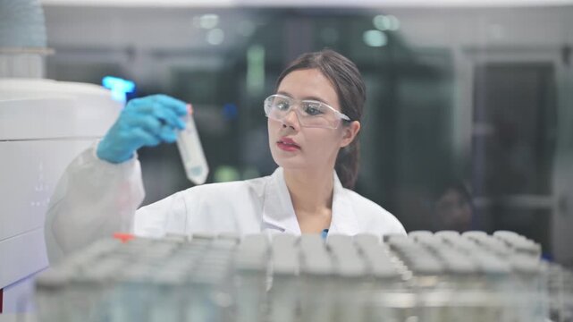 Scientist works in laboratory taking notes and handling samples in evening hours