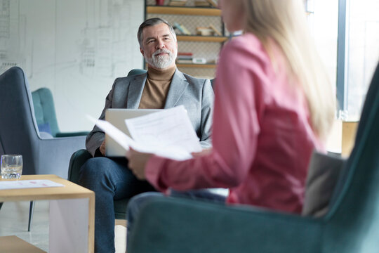 Happy mature businessman professional bank manager or financial advisor consulting woman client