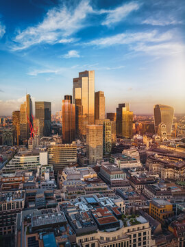Aerial view of the financial district City of London, England, skyscraper cluster during a golden sunset