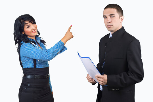Woman points accusingly at man holding documents