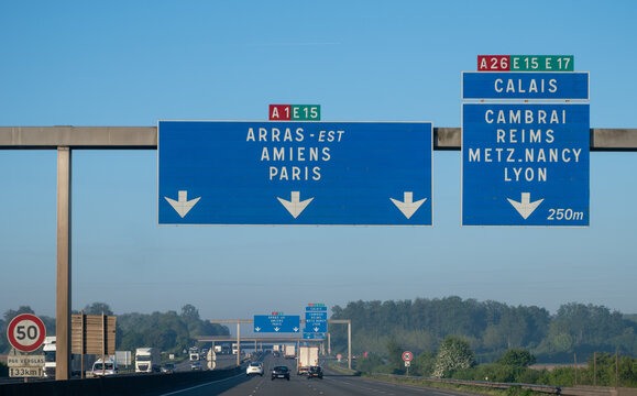 View of a French and European autoroute with overhead directional signs pointing to major cities like Paris, Bordeaux, Lille, Calais, showing lanes, traffic and motorway infrastructure, road signes