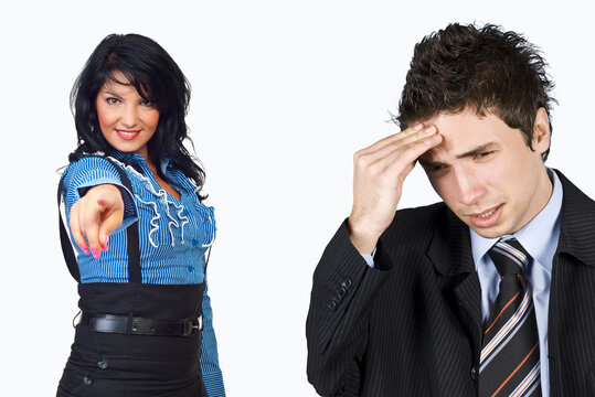 Woman points accusingly at a stressed man