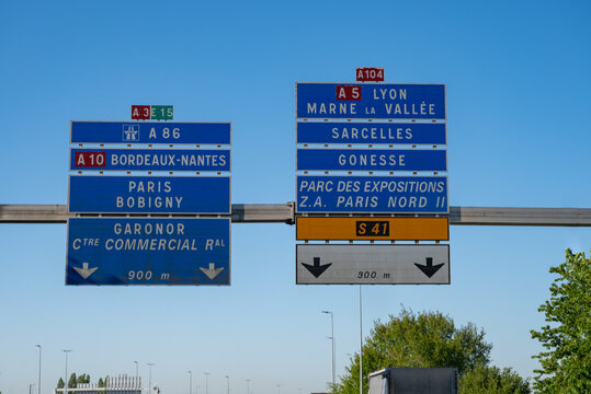 View of a French and European autoroute with overhead directional signs pointing to major cities like Paris, Bordeaux, Lille, Calais, showing lanes, traffic and motorway infrastructure, road signes
