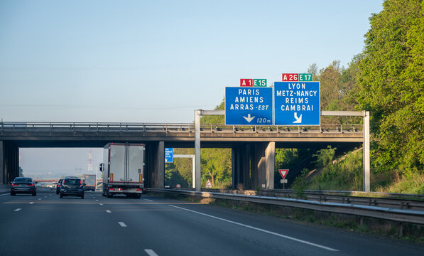View of a French and European autoroute with overhead directional signs pointing to major cities like Paris, Bordeaux, Lille, Calais, showing lanes, traffic and motorway infrastructure, road signes