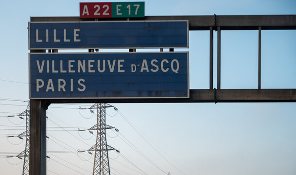 View of a French and European autoroute with overhead directional signs pointing to major cities like Paris, Bordeaux, Lille, Calais, showing lanes, traffic and motorway infrastructure, road signes