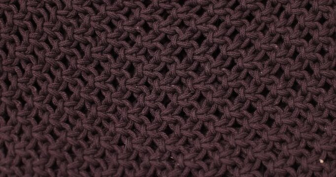 Close-up of dark purple knitted fabric texture