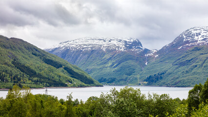Highland water resources surrounded by snow covered mountains and calm landscape , scandinavian mountain environment for travel and geography themes. Haukeli, Norway © Nimbus Works