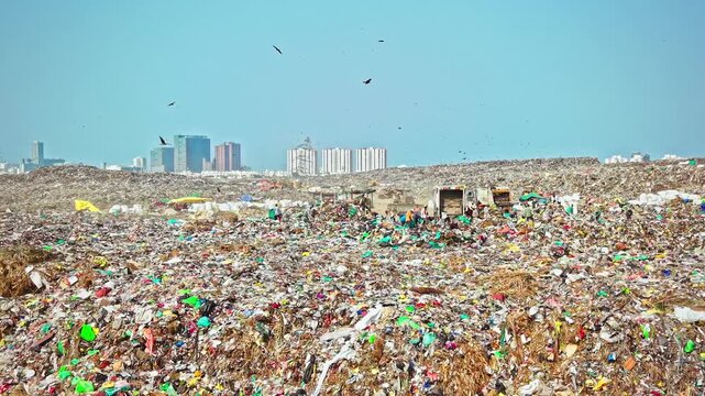 Bulldozer Pushing Through Waste At Municipal Landfill Dump Yard
