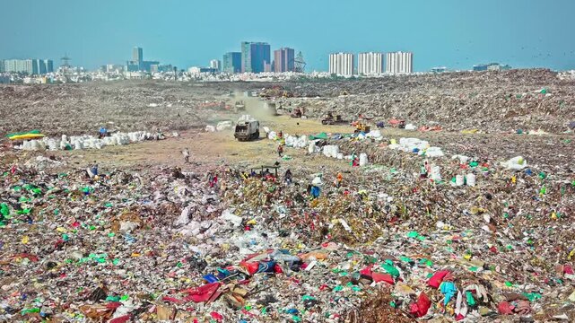 A bulldozer pushes through large volumes of waste at a municipal landfill site, supporting waste management and disposal operations