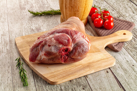 Raw pork knuckle over board