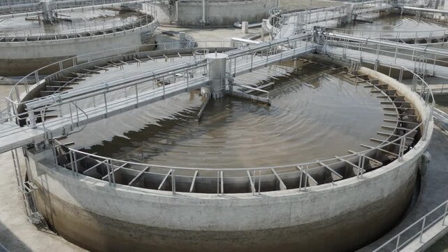 Medium shot of a clarifier in a water treatment unit showing sedimentation of solids from process effluents before reuse or release into the environment