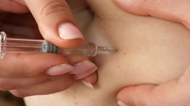Young Woman Self-Injecting Medication into Abdomen at Home Close Up Healthcare Treatment