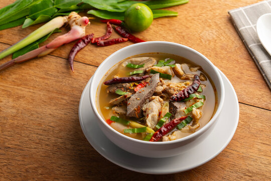 Hot and Spicy Pork Offal Soup.Thai boiled Sour Soup in white bowl.(Tom Saep)