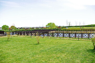Fototapeta premium Historical park in Neofit Rilski, Bulgaria, overlooking a large lake with fences and passages, symbolically connecting the different eras of our lands 