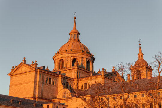 San Lorenzo de El Escorial, Spain. Dome and apse of the basilica of the Royal Monastery (1563-1584), inspired by St Peter's in Rome, designed by Juan de Herrera, bathed in sunrise light