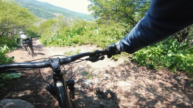 Cyclist ride bicycle at mountain trail road