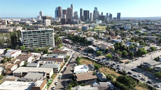 Los Angeles, California, USA - Aerial pullback Drone View of Downtown Los Angeles Skyline and Skyscrapers Rising Above Residential Neighborhoods Near Everett Park and Echo Park on a Sunny Day