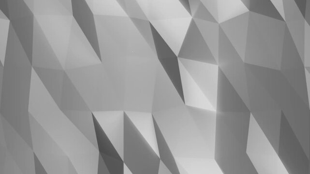 Gray low poly geometric surface with angular facets and soft shadows