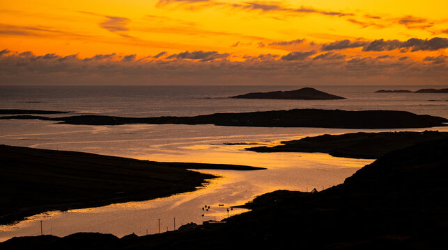 Sunset glows over Clifden Bay and the Atlantic islands from the Sky Road viewpoint in Connemara, County Galway. A scenic evening view from one of Irelands best coastal lookouts. Wild Atlantic Way.