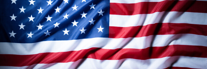 Fototapeta premium Panoramic american flag banner with patriotic fabric folds background