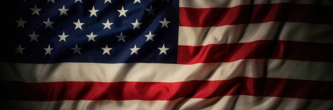 Panoramic dark american flag background with dramatic patriotic folds