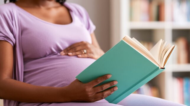 expectant mother reading a prenatal book at home, hand on baby bump in cozy living room with bookshelf &mdash; maternal preparation and care