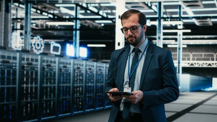Data center software developer using tablet and augmented reality to install upgraded server racks systems, Employee using automation app on device to monitor server hub, VFX overlay, camera B. © DC Studio