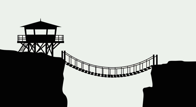 Silhouette of a lookout tower and suspension bridge connecting two cliffs