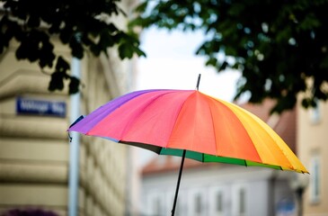 Colorful rainbow umbrella on rainy city street during pride parade in Klagenfurt Austria © HelgaQ