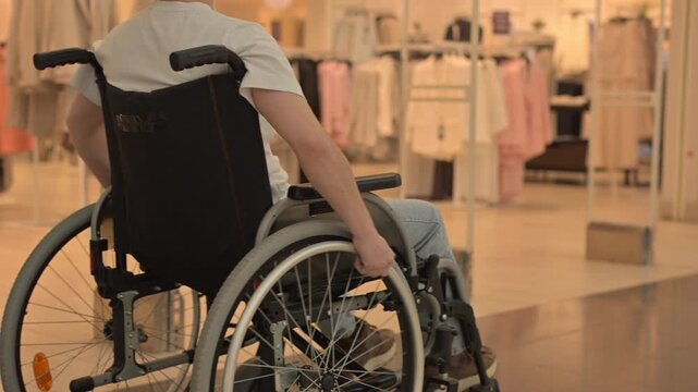 A Caucasian woman in a wheelchair shopping at a mall. 
