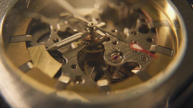 Close view of watch movement showing gears, hands, and mechanisms in action during daylight hours in a quiet room