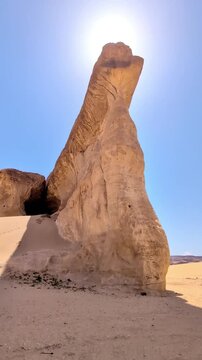 View of a big rock in Saudi Arabia Alula desert with the rock mountains at background on a sunny day.