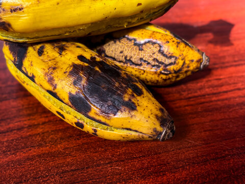 Delicious steamed bananas or pisang rebus, a traditional healthy food from Indonesia. Isolated by wooden background. Close up shot. Healthy food.