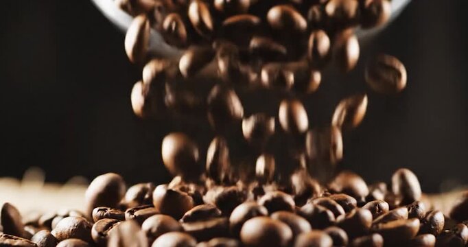 Roasted Coffee Beans Falling and Piling Up on a Surface in Slow Motion