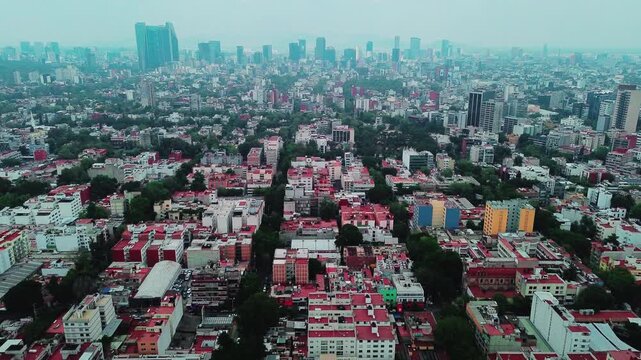 Mexico City Traffic Flow and Skyline Skyscrapers with Misty Brume During Bright Daylight Forward Camera Flight Aerial Drone POV 4K 29fps Editorial Video Asset