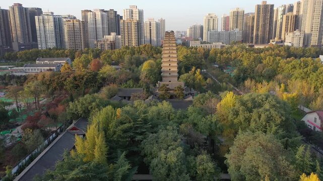 Ancient pagoda above autumn temple garden and modern skyline in Xi'an China