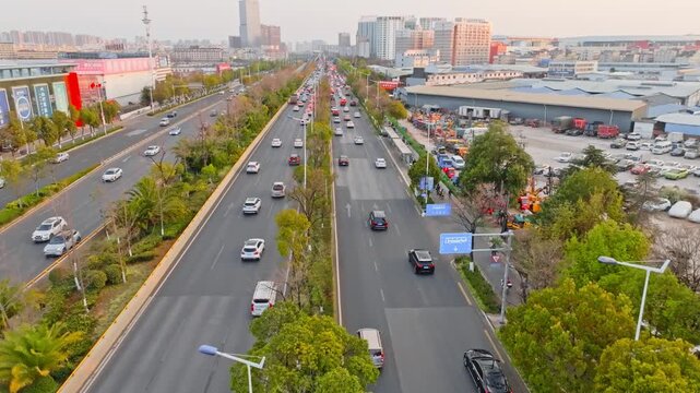 Aerial view of busy urban boulevard traffic in a Chinese city at sunset in China