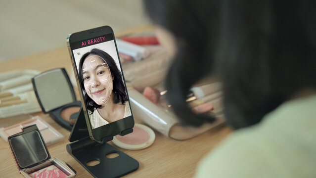 Asia people young gen z female happy smile enjoy phone apply selfie screen makeup blush virtual AI tech scan face app AR mixed augmented reality future beauty smart iot skin care help guide advice.