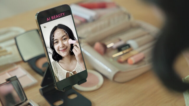 Asia people young gen z female happy smile enjoy phone apply selfie screen makeup blush virtual AI tech scan face app AR mixed augmented reality future beauty smart iot skin care help guide advice.