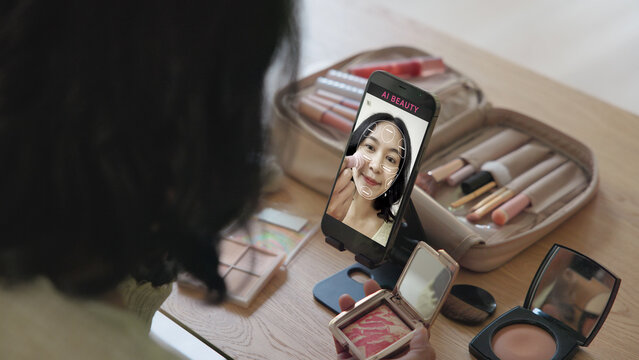 Asia people young gen z female happy smile enjoy phone apply selfie screen makeup blush virtual AI tech scan face app AR mixed augmented reality future beauty smart iot skin care help guide advice.