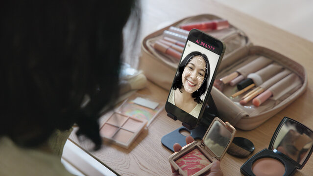 Asia people young gen z female happy smile enjoy phone apply selfie screen makeup blush virtual AI tech scan face app AR mixed augmented reality future beauty smart iot skin care help guide advice.