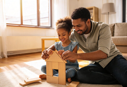 Happy african american father and daughter building wooden block house, family playing on living room floor, joyful black dad helping little girl, creative learning toys, indoor quality time.