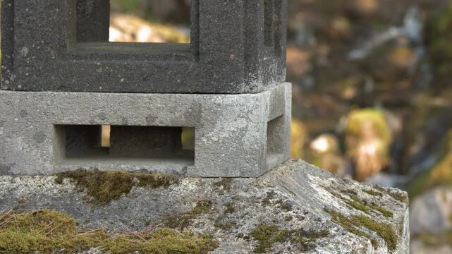Traditional Japanese Stone Lantern Base in a Zen Garden Setting