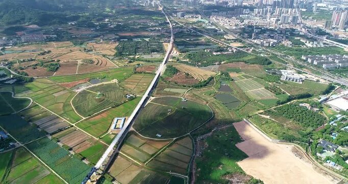Aerial view of highway crossing patchwork farmland and rural fields