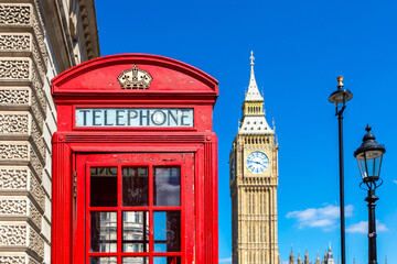 Obraz premium Classic Red Telephone Box with Big Ben clock tower in Westminster, London, England, UK