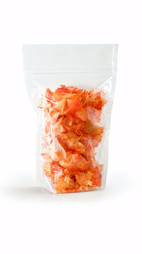 Spicy red chili cassava chips packaged in a transparent clear plastic standing pouch. Authentic crispy Indonesian snack, perfect for spicy food lovers.