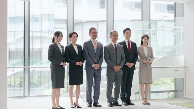 ロビーに整列する幅広い世代の男女ビジネスパーソンのグループ