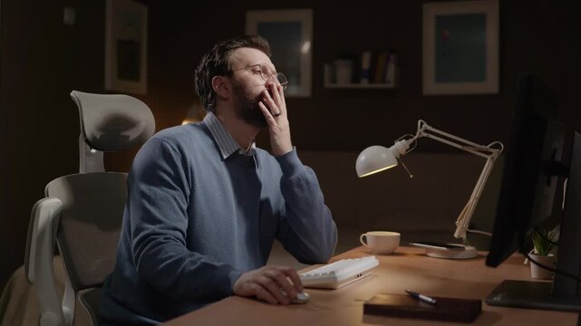 Frustrated man stares at computer screen and places his palm over his face as sign of sarcasm and disagreement. Facepalm, sarcasm, frustration