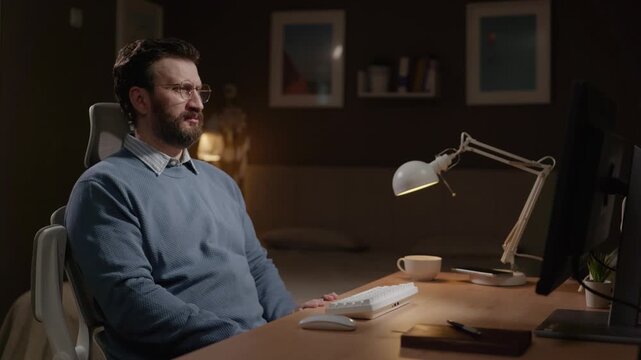 Man at computer sees something disgusting on monitor screen. Disgust concept